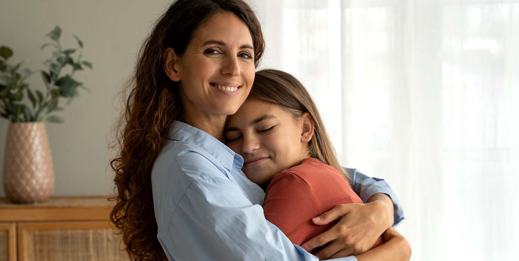 mom hugging daughter